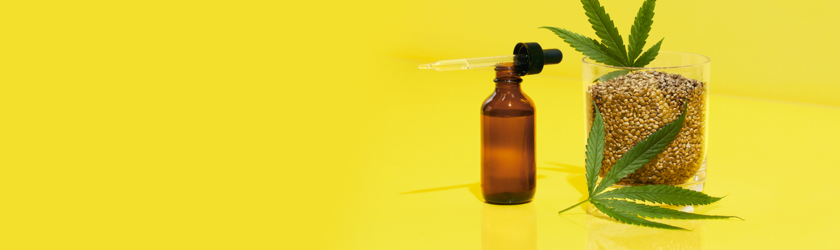 Tincture bottle with jar of hemp seed