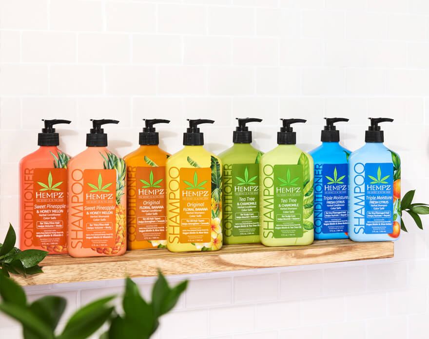 Hempz hydrating haircare on a wooden shelf with leaves