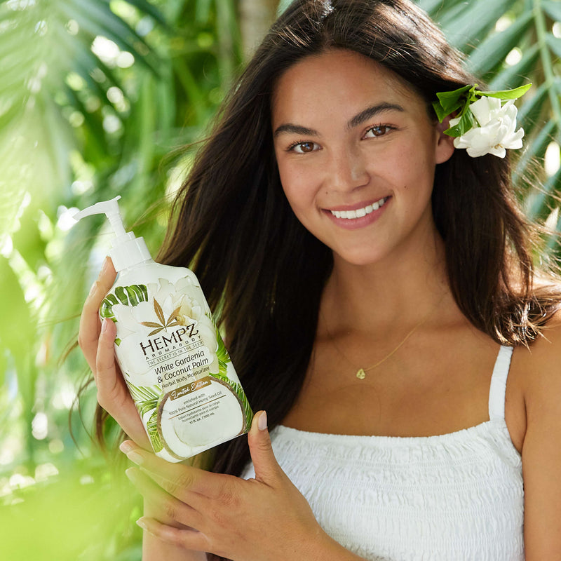 Model holding Hempz White Gardenia & Coconut Palm Herbal Body Moisturizing Lotion
